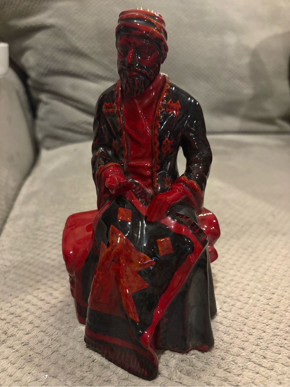 Royal Doulton Red and Black Glazed Seated Figure Sculpture